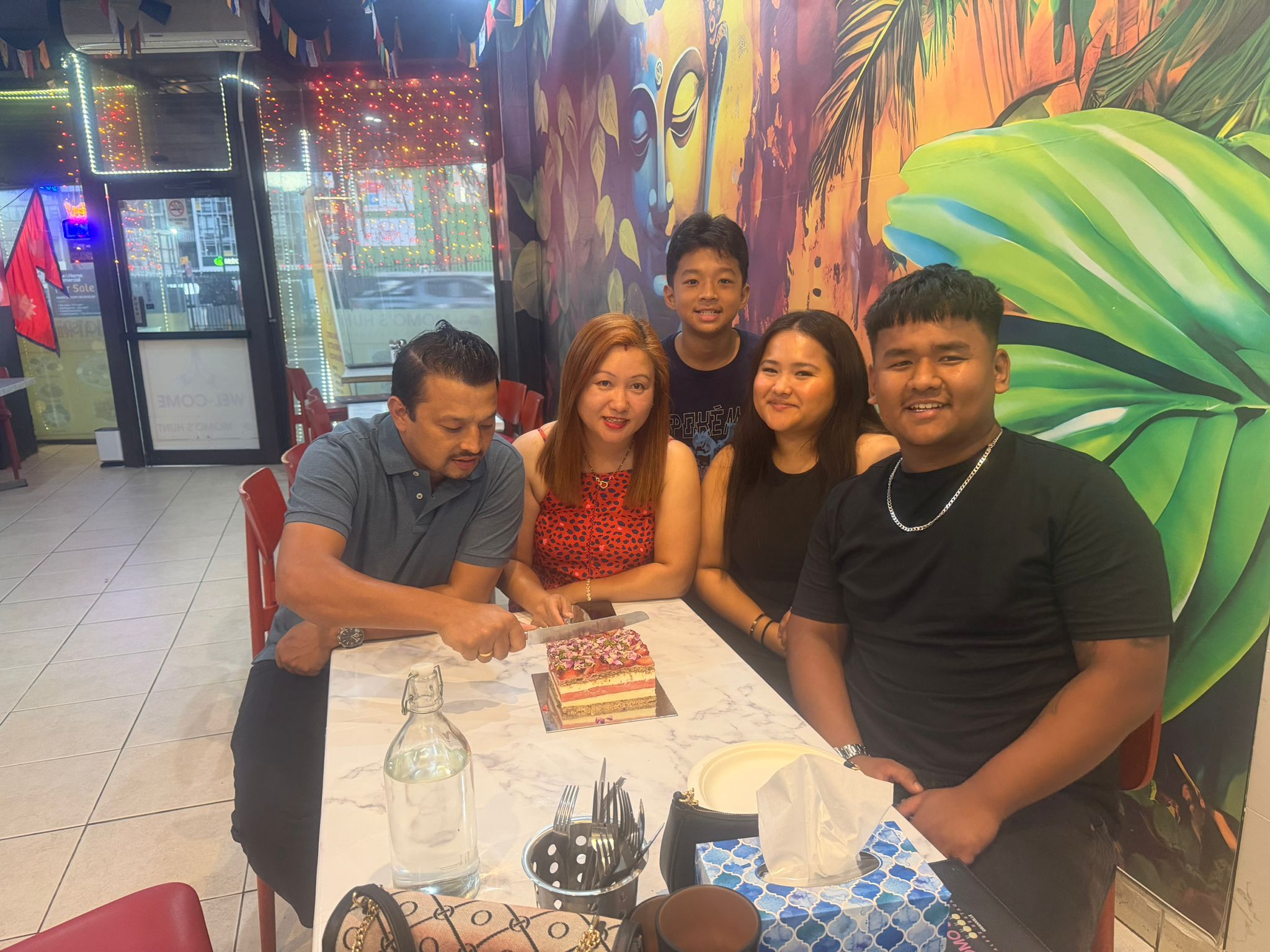 A family celebrating with a cake inside Momo's Hunt