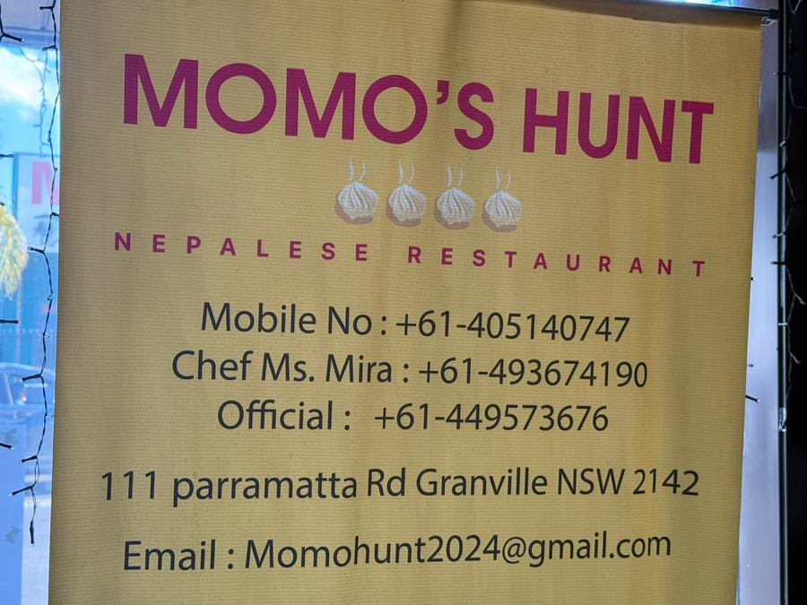 Momo's Hunt street sign with phone numbers and address